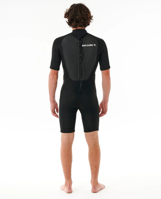 Person wearing a black wetsuit with Rip Curl logo on a white background SHED NINE