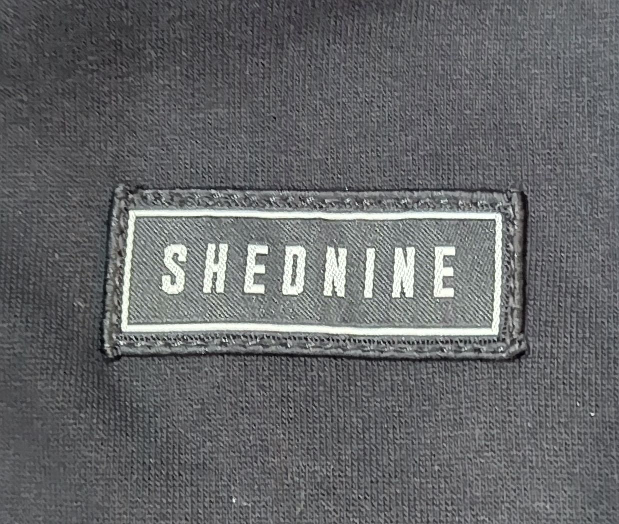 Text 'SHEDNINE' on a black background