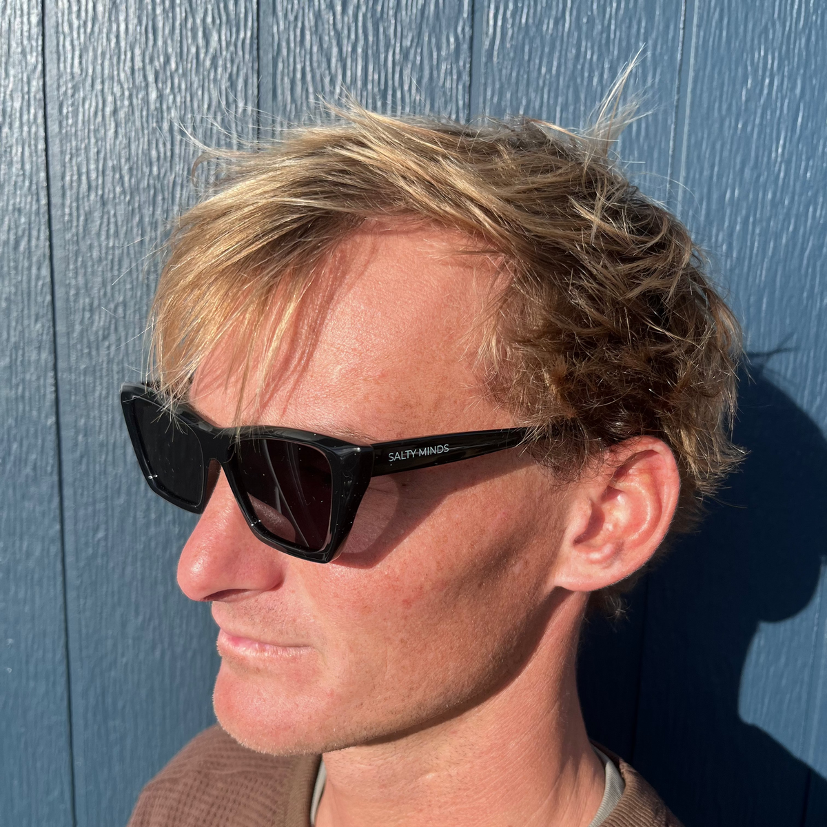 Salty Minds Seabreeze black sunglasses worn at an angle