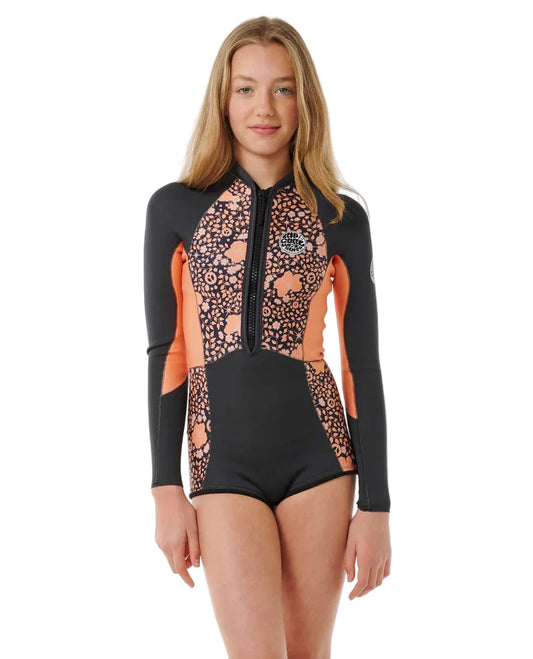 Woman wearing a black and orange patterned swimsuit on a white background shed nine