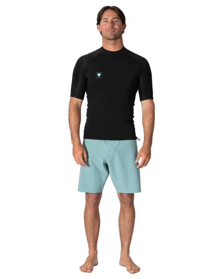 Man wearing a black Rash Guard and light blue shorts on a white background - shed nine