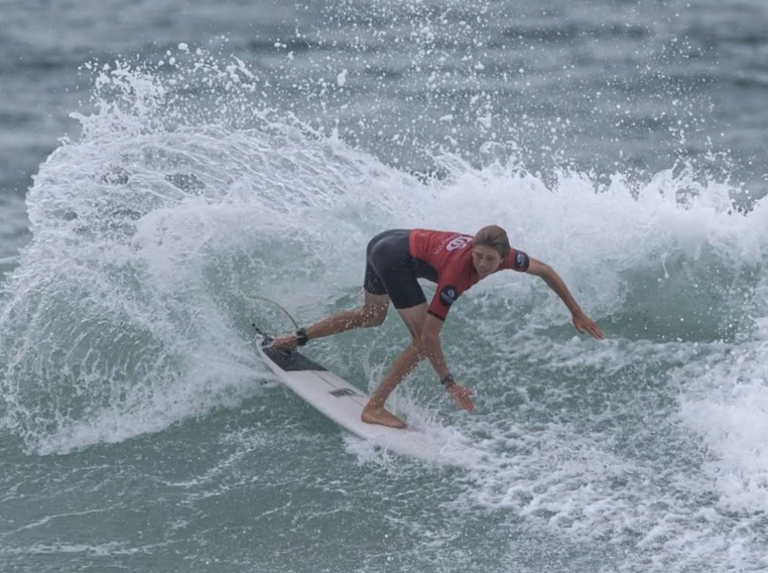 Person surfing on a wave in the ocean