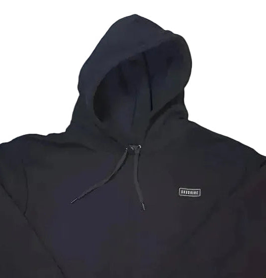 Black hoodie with a small logo on a white background, pre-order now text at the top.