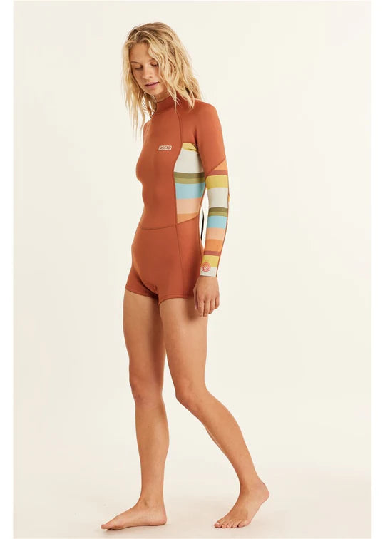 Woman wearing a brown wetsuit with colorful stripes on a beige background shed nine