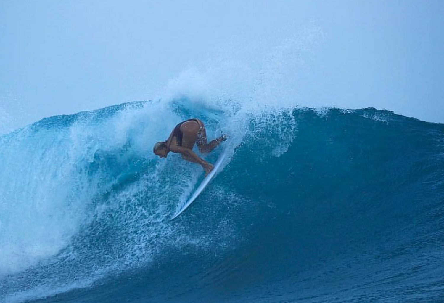 Surfer riding a large wave in the ocean