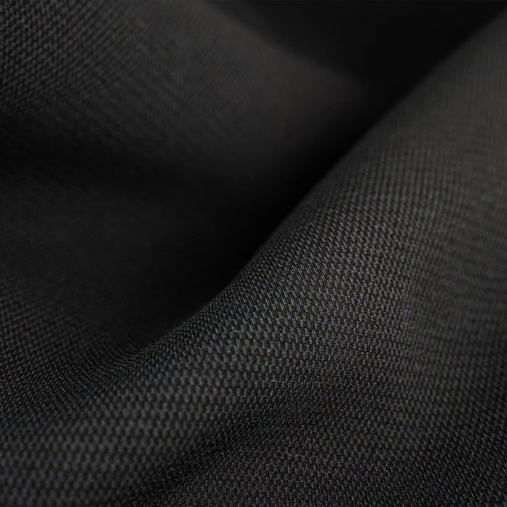 Close-up of black fabric with a textured pattern shed nine