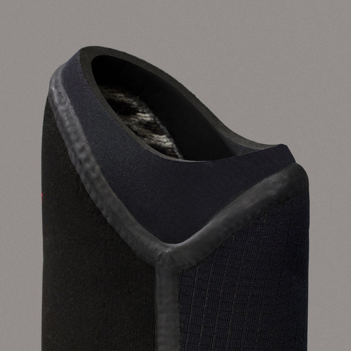 Black shoe with a textured sole on a gray background shed nine