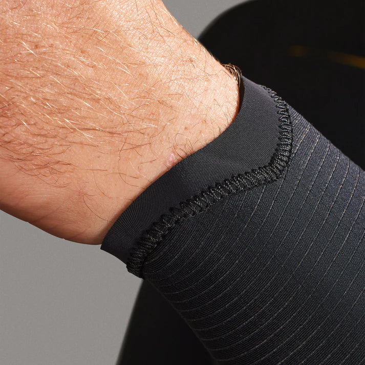 Close-up of a person wearing a black sleeve with a gray background shed nine