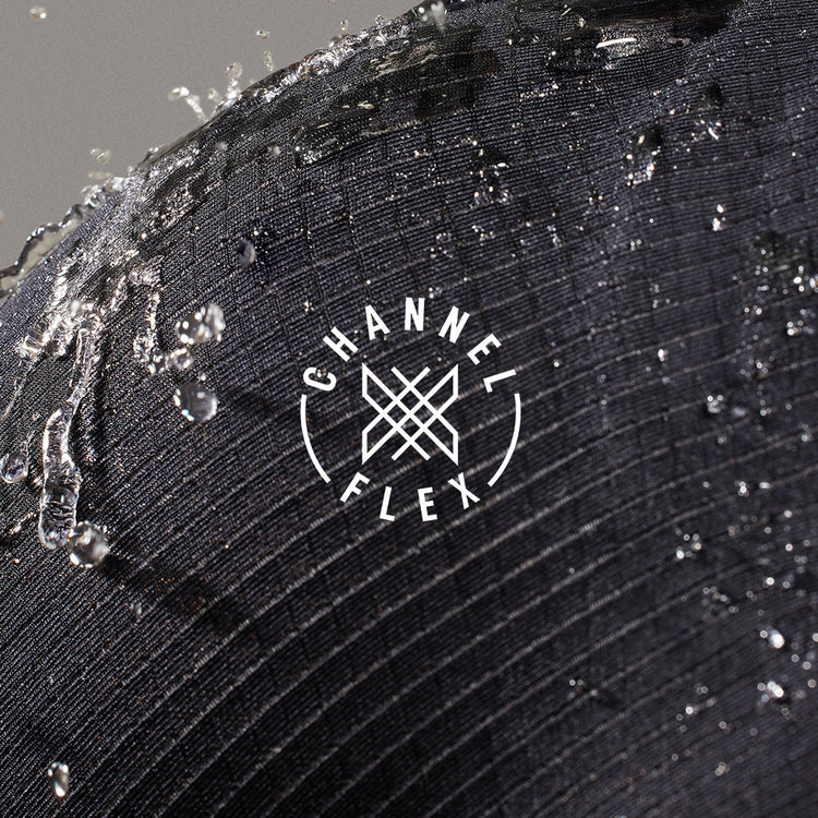 Close-up of a black textured surface with water droplets and 'Channel Flex'      shed nine logo.