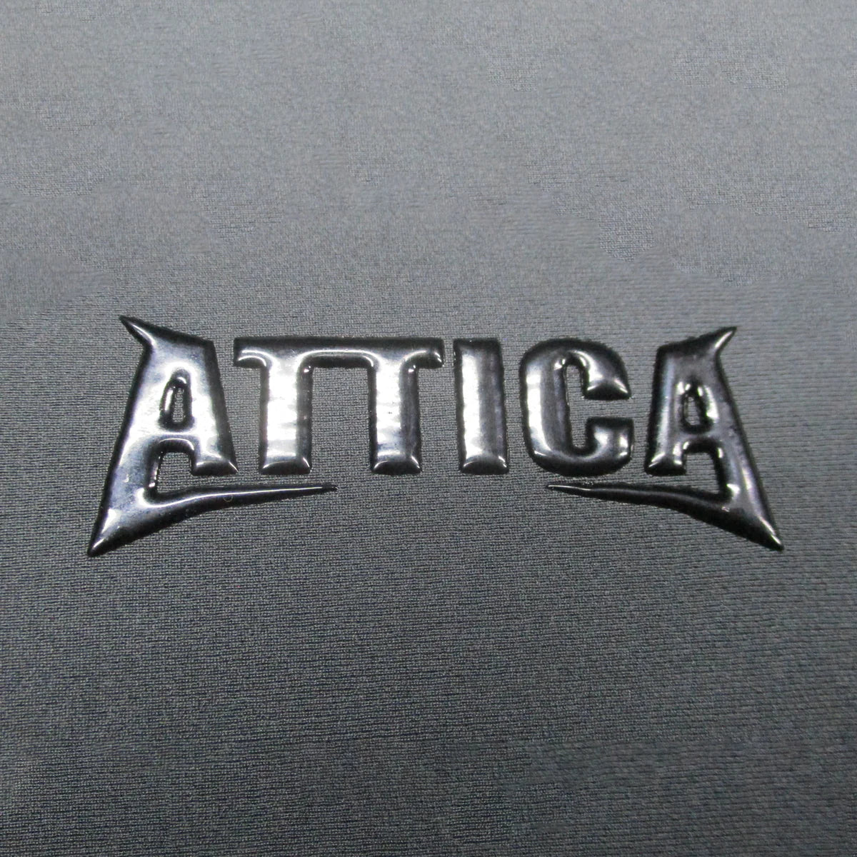 Attica logo detail on Omega Chest Zip 3/2mm Steamer Wetsuit in Black Noir shed nine