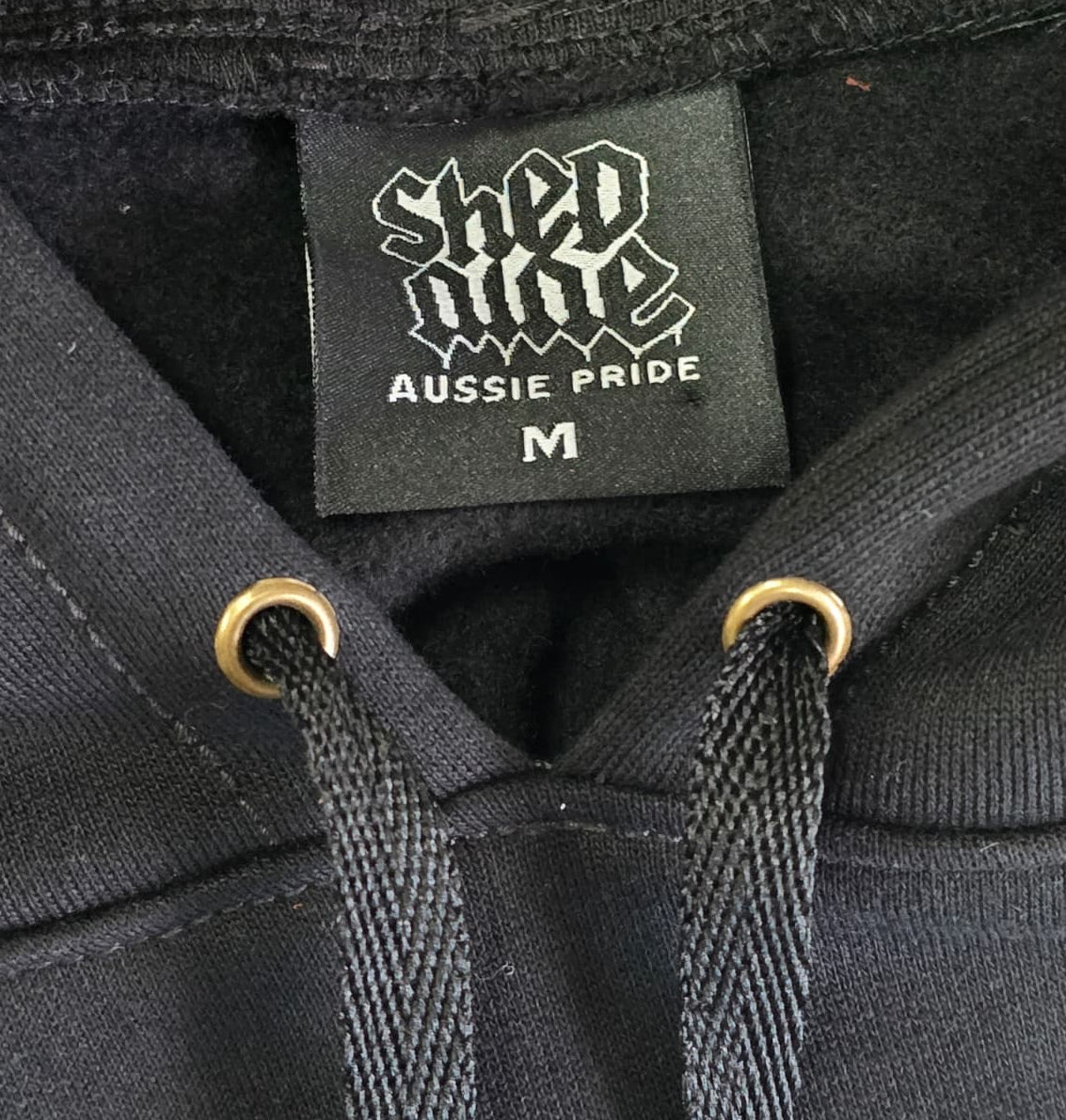 Black hoodie with a brand label on the chest shed nine