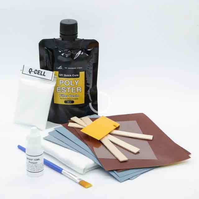 SurfBoardStudio UV Polyester Repair Kit, resin pouch and repair materials laid out