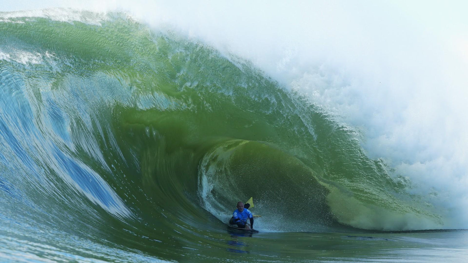 Person surfing inside a large wave