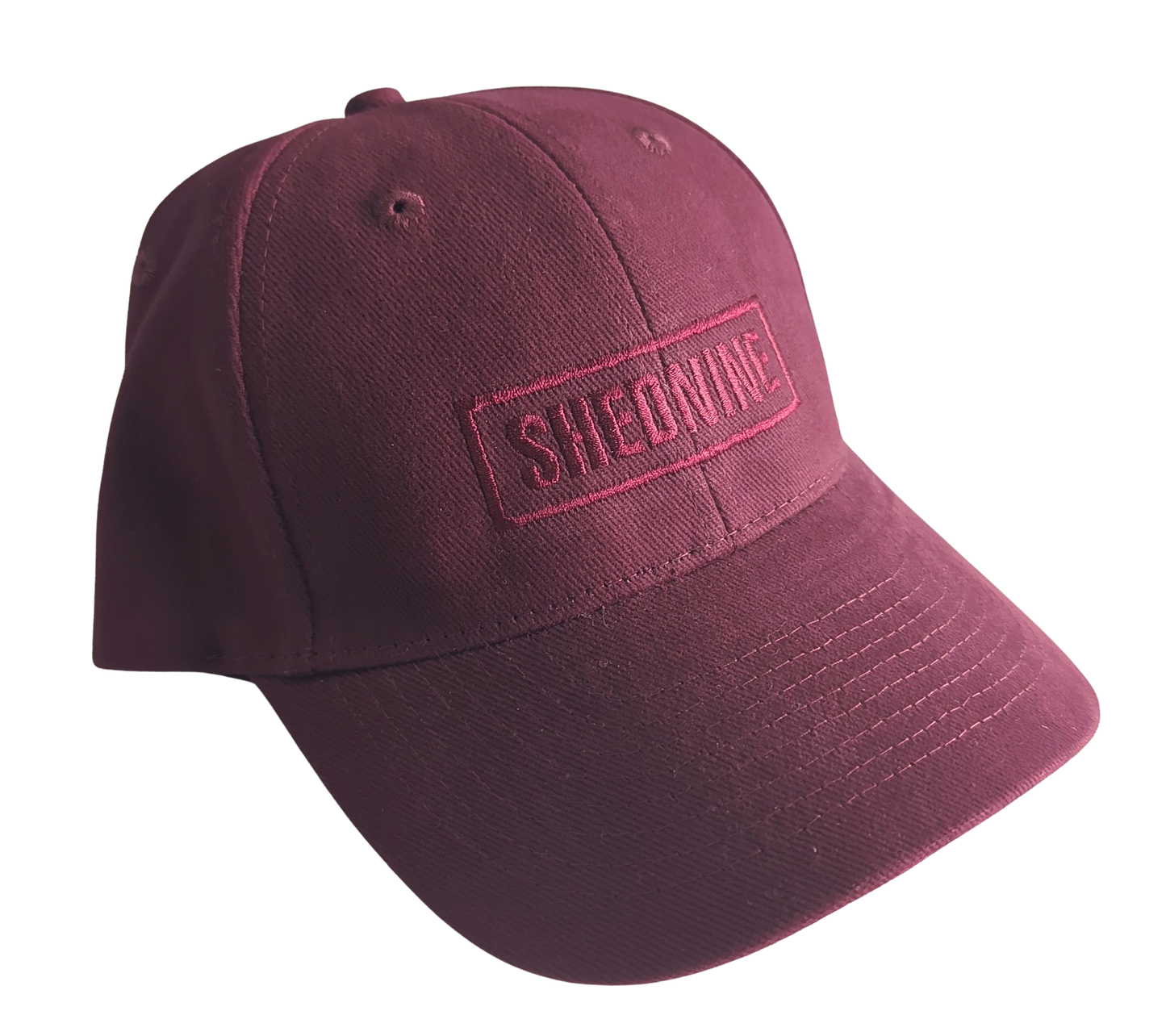 Maroon cap with 'SHEDNINE' logo on a white background