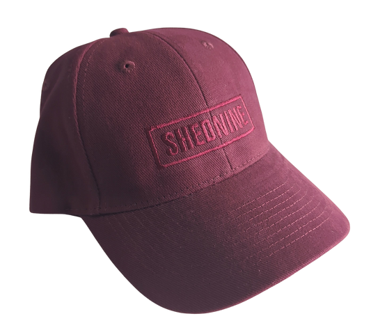 Maroon cap with 'SHEDNINE' logo on a white background