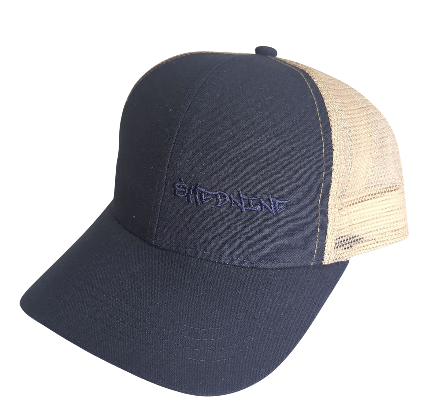 Navy blue and beige trucker cap with 'Shed Nine' logo on a white background