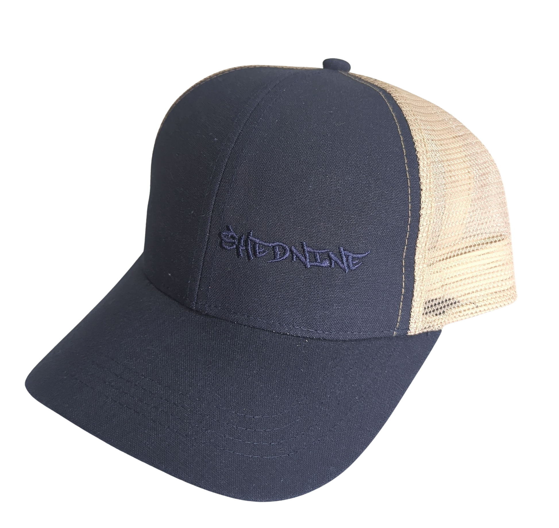 Navy blue and beige trucker cap with 'Shed Nine' logo on a white background