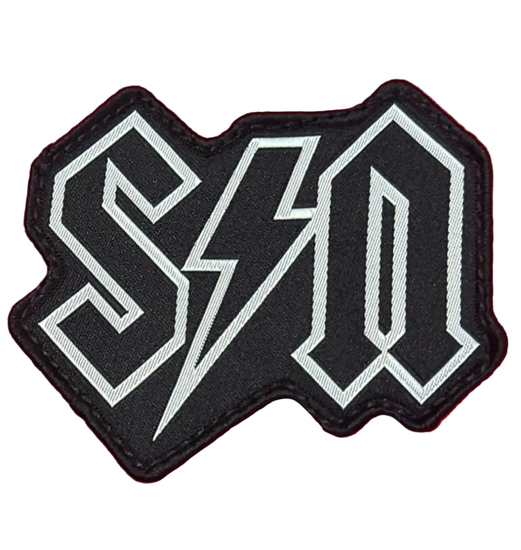 Black and white logo patch on a red background