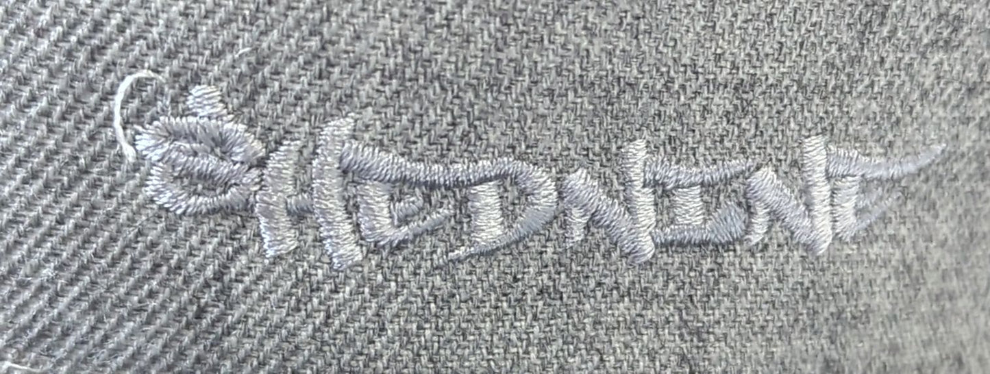 Embroidered text on a textured fabric background