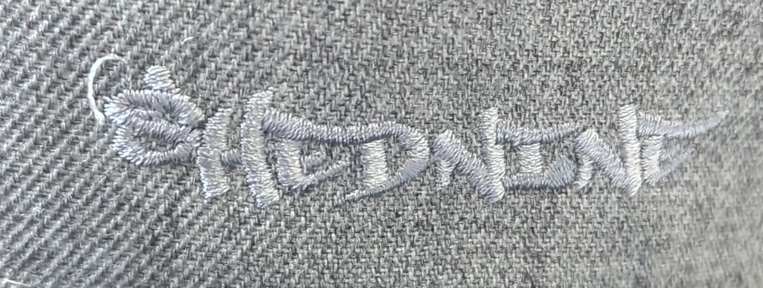 Embroidered text on a textured fabric background