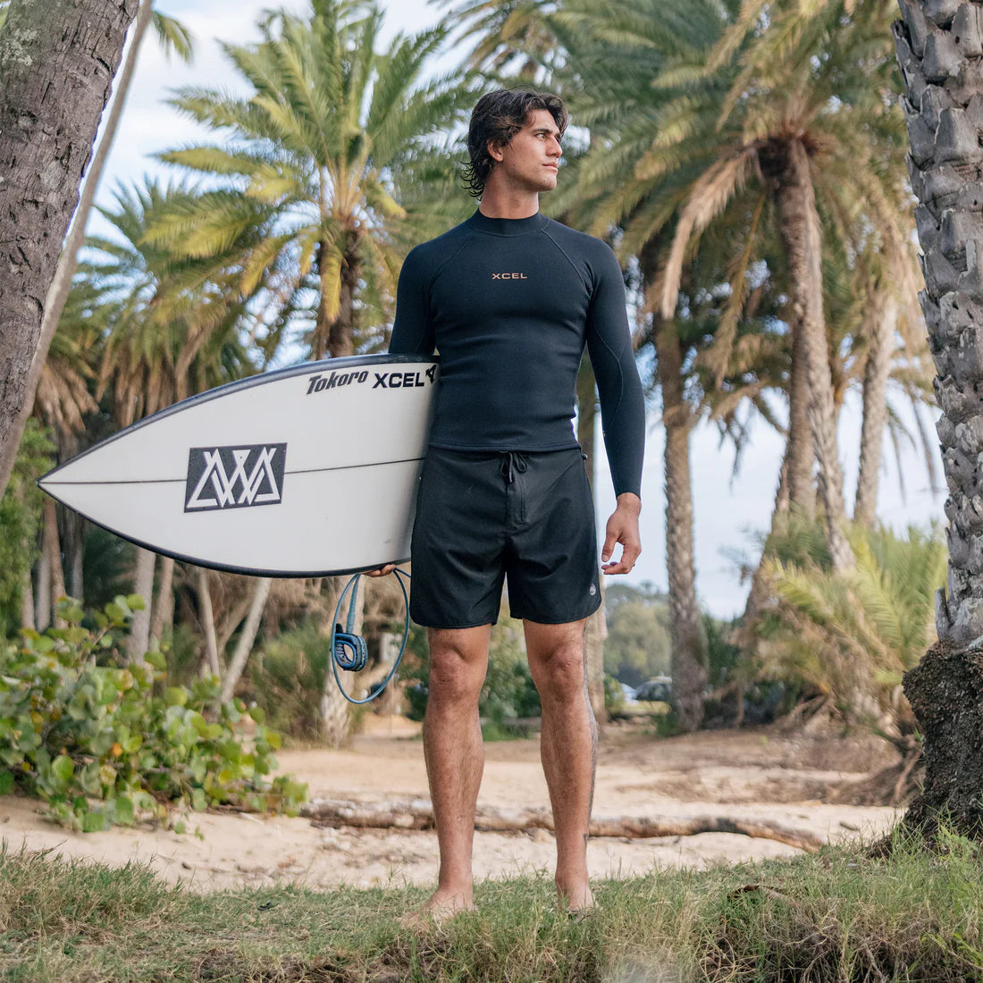 Xcel men's Comp+ 1mm black long sleeve wetsuit jacket worn with boardshorts