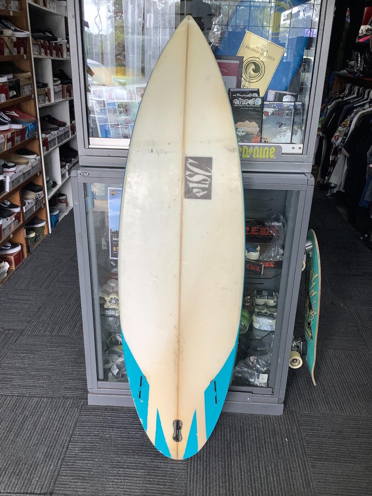 Used PISC surfboard bottom with blue tail accents and empty fin boxes