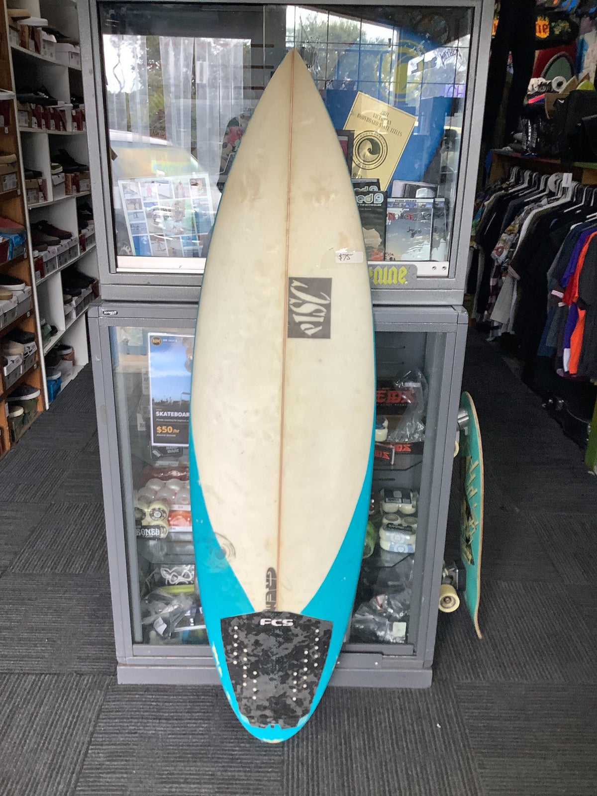 Used PISC surfboard deck with blue rails and black FCS traction pad