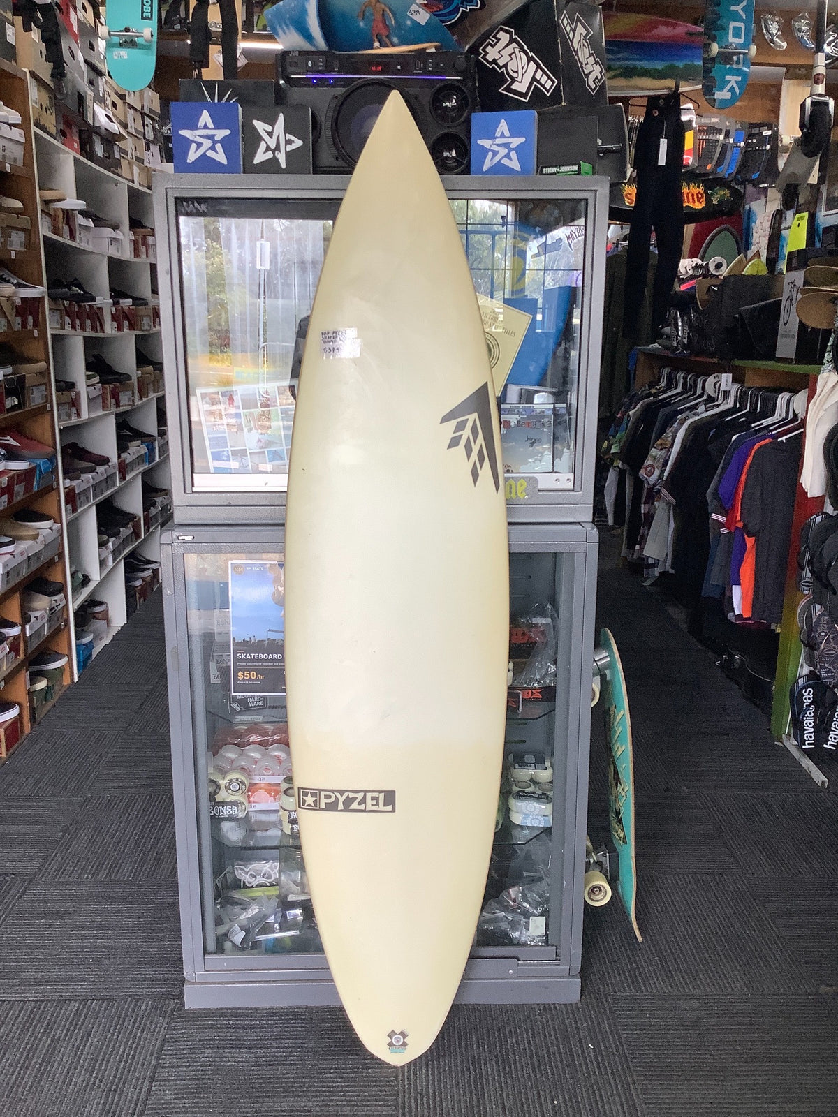 Deck of second-hand Pyzel x Firewire surfboard showing both brand logos