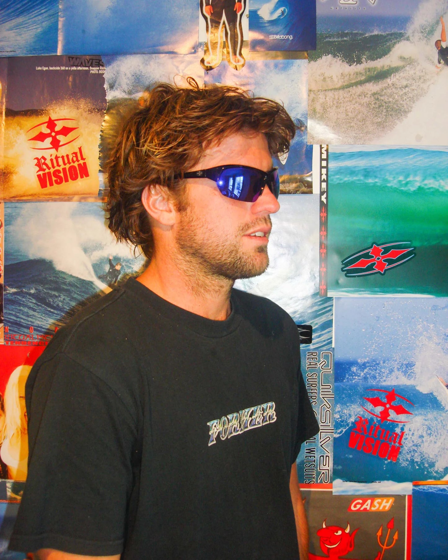 Portrait of model wearing Ritual Vision Break & Enter Sunglasses in Polished Black / Reflective Blue shed nine