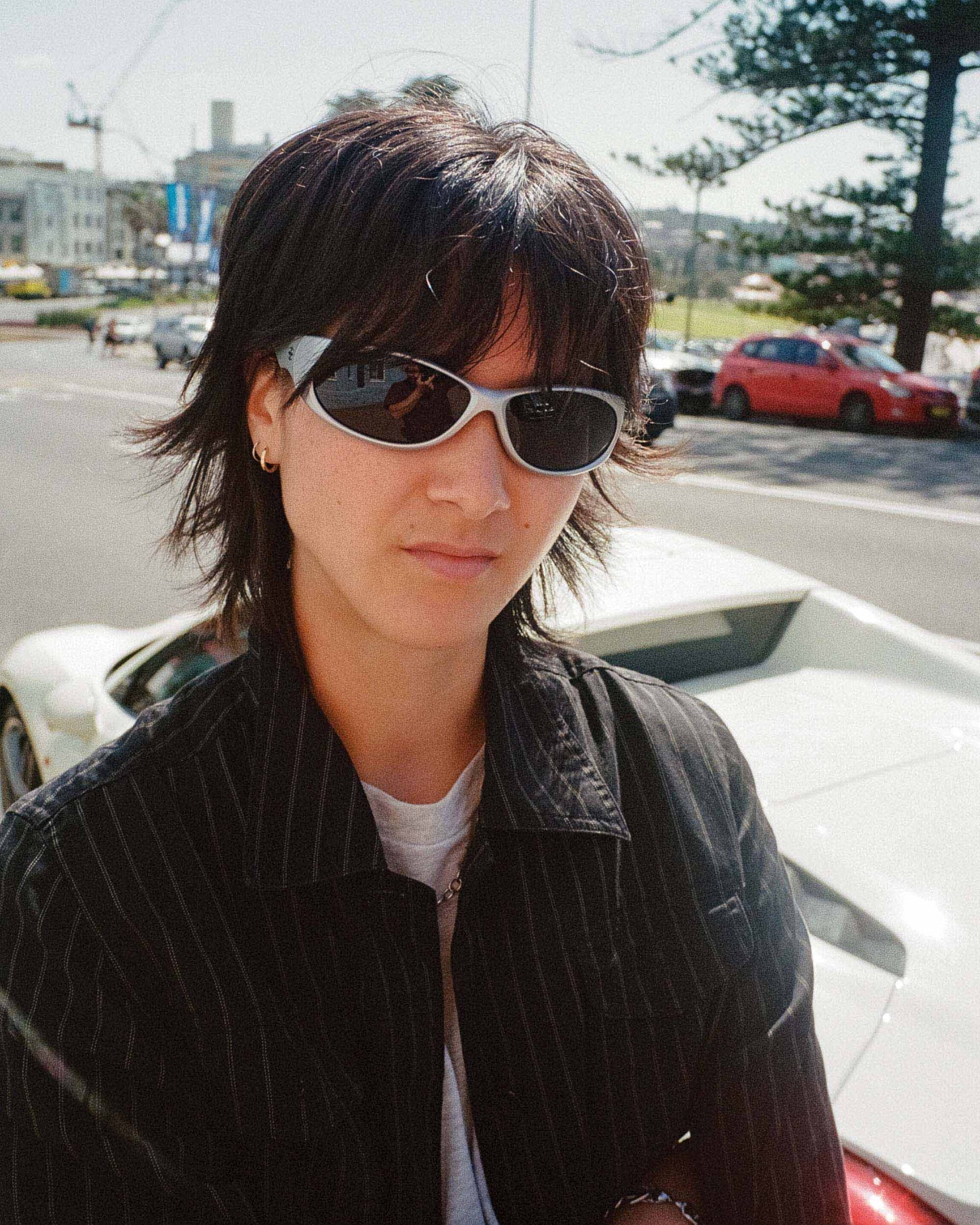 Outdoor portrait of model wearing Ritual Vision Demon Speed Sunglasses in Combat / Bronze Polarised shed nine