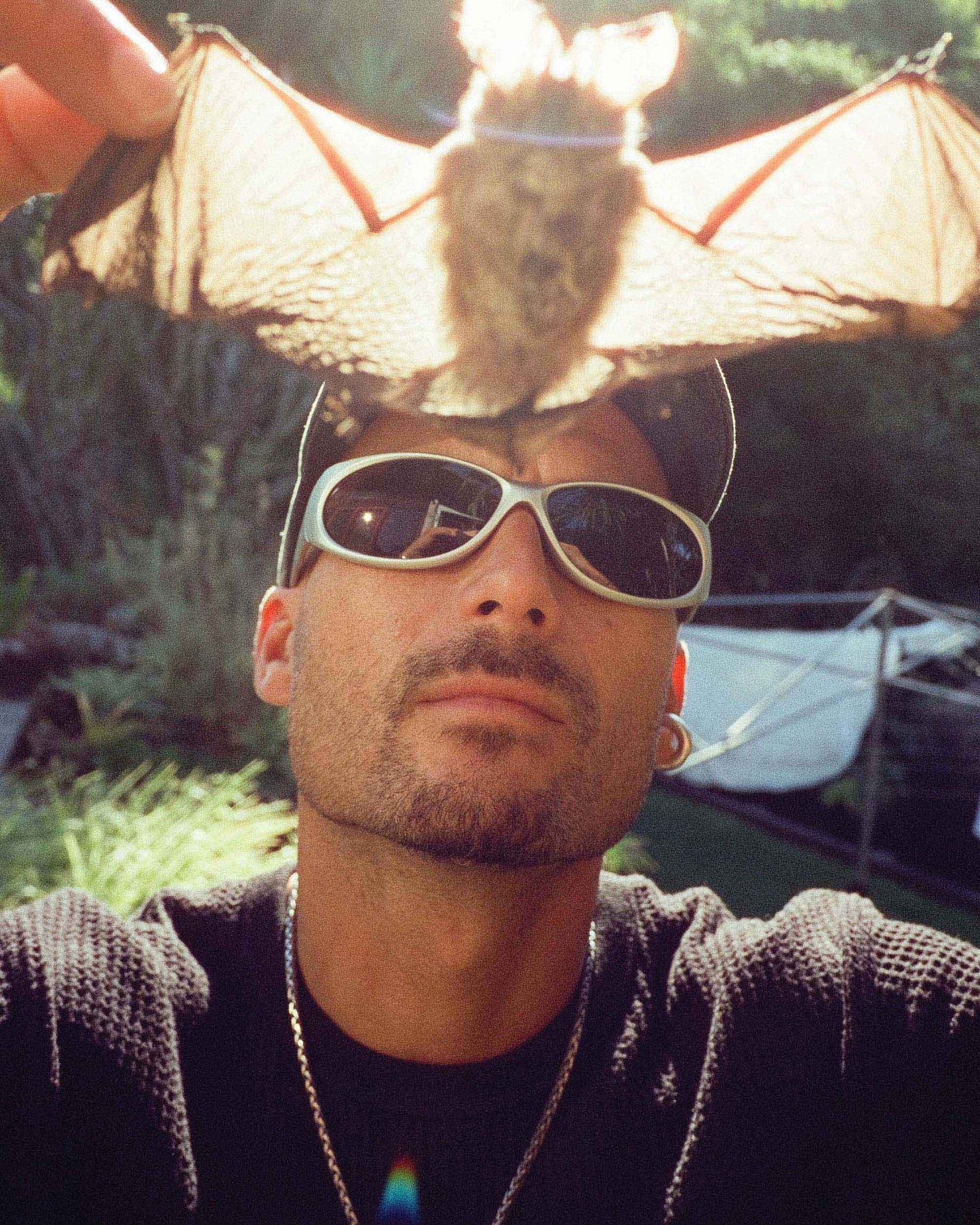 Lifestyle portrait of model wearing Ritual Vision Demon Speed Sunglasses in Combat / Bronze Polarised shed nine