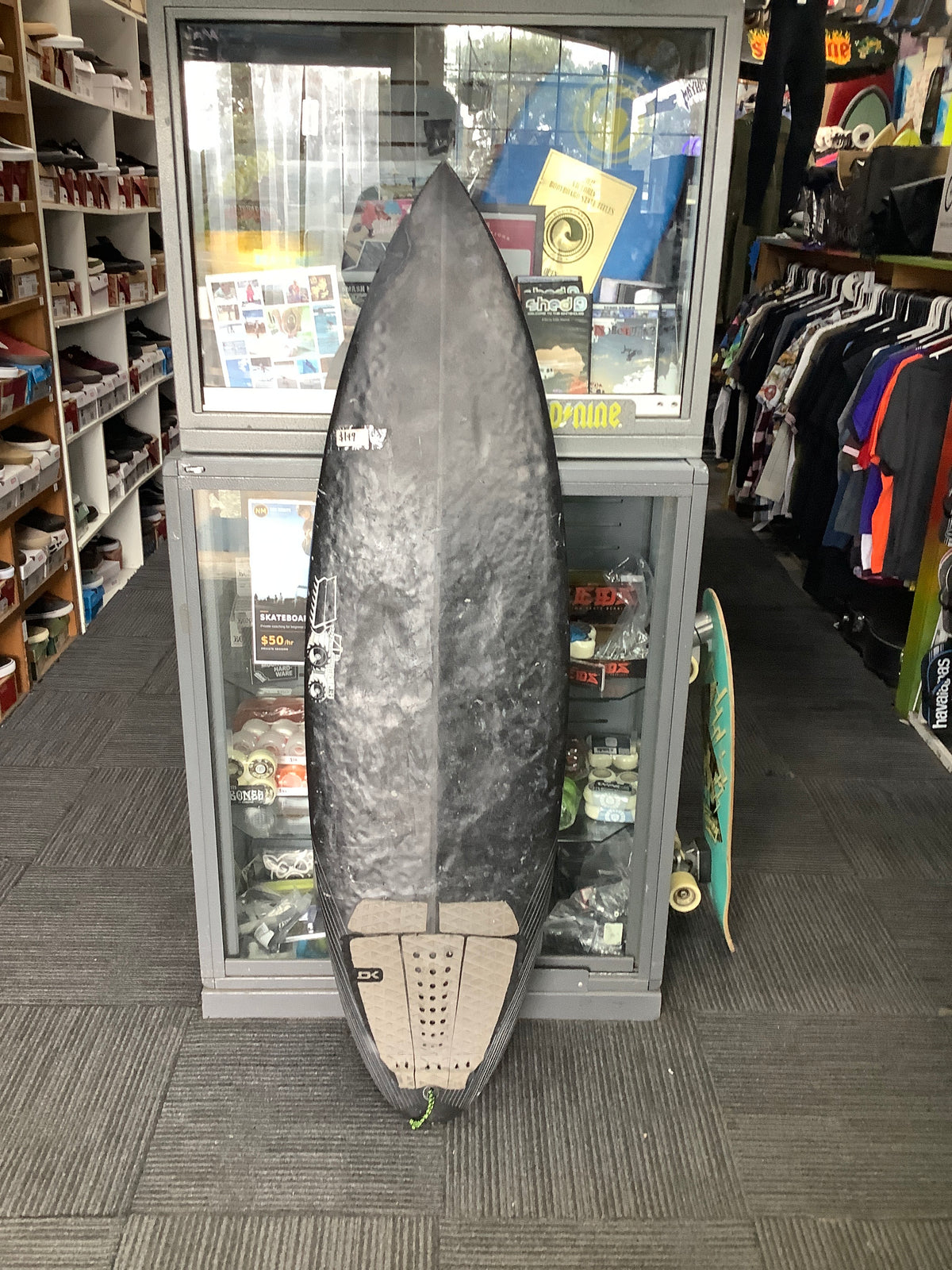 Second-hand black JS Industries surfboard deck with tail pad