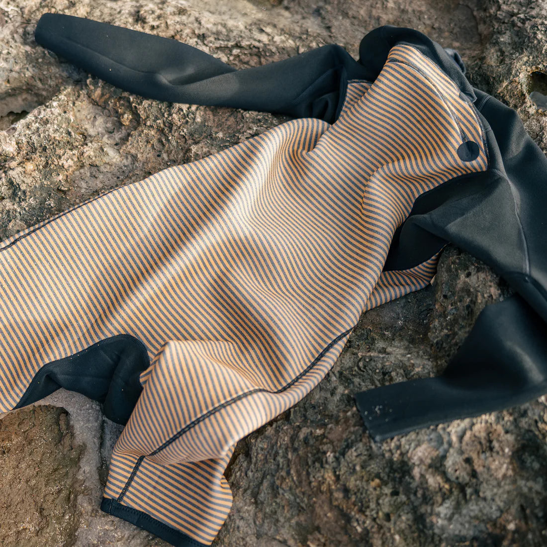 Xcel Comp+ 2mm long-sleeve springsuit showing the striped Thermo Dry Infrared interior