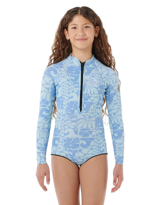 Girl wearing a blue patterned swimsuit with long sleeves on a white background shed nine