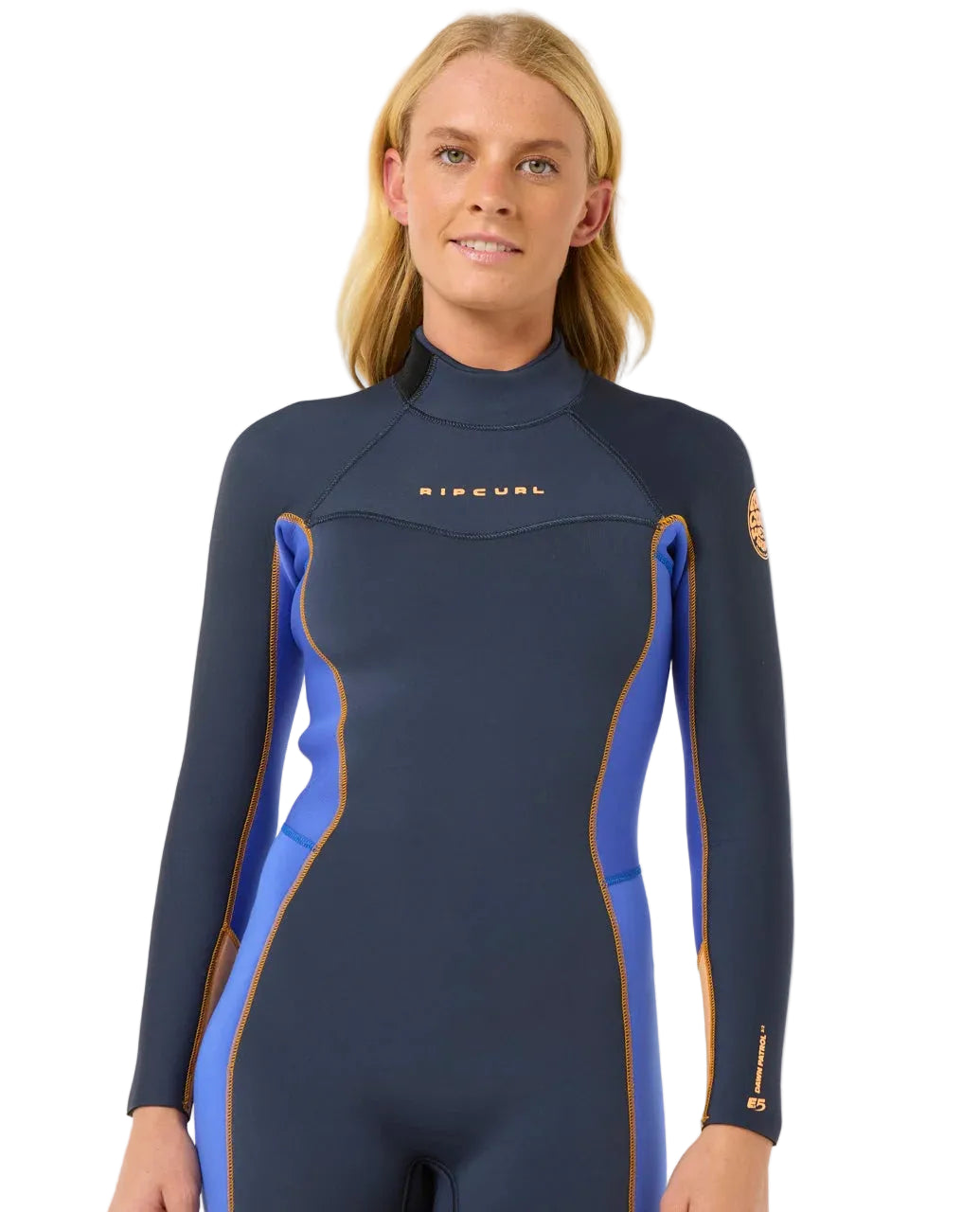 Woman wearing a navy and blue wetsuit with Rip Curl branding on a white background shed nine