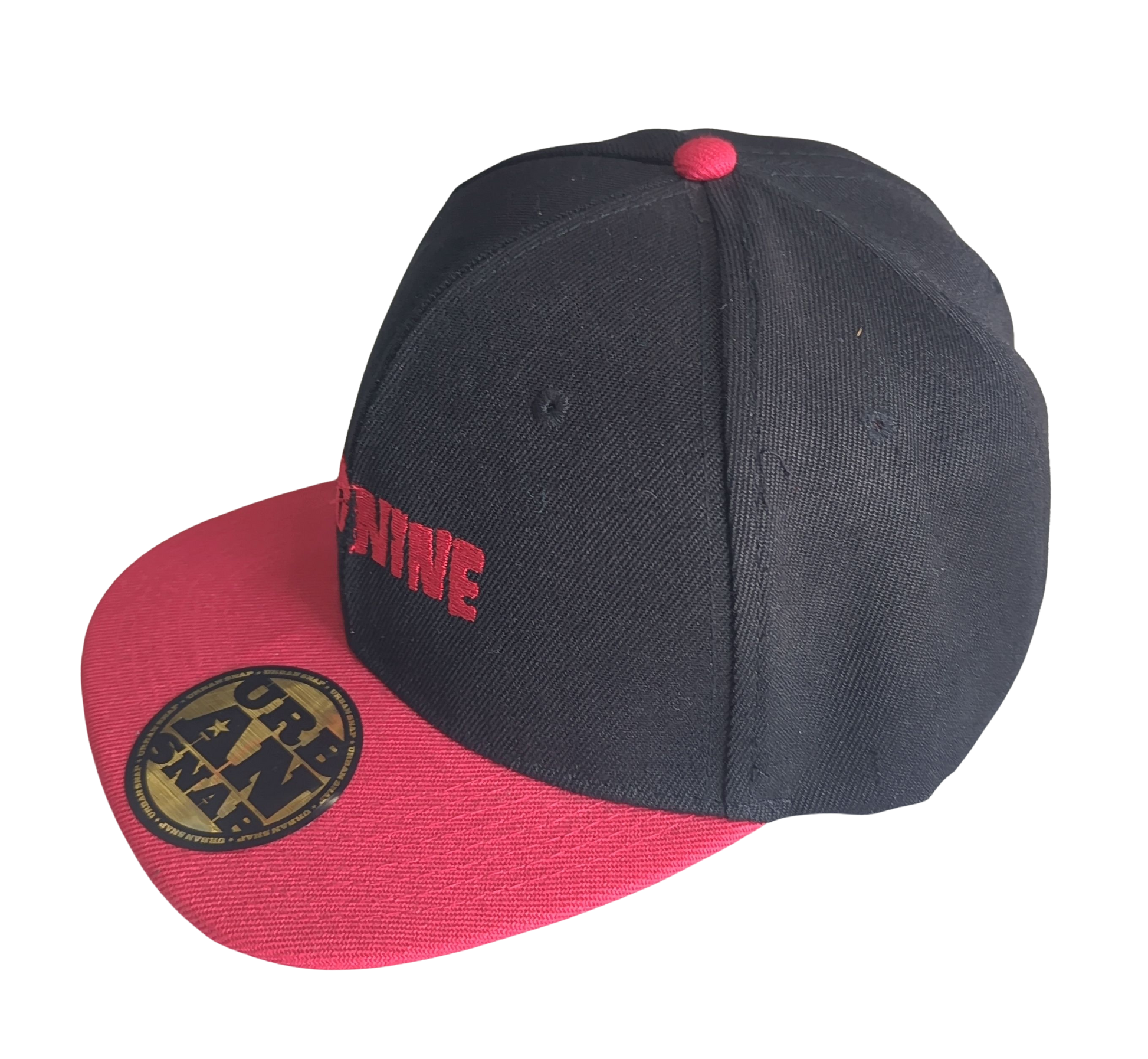 Black and red cap with visible branding on a white background