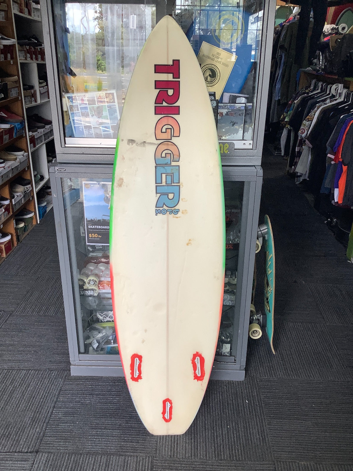 Used Trigger Brothers surfboard bottom showing condition
