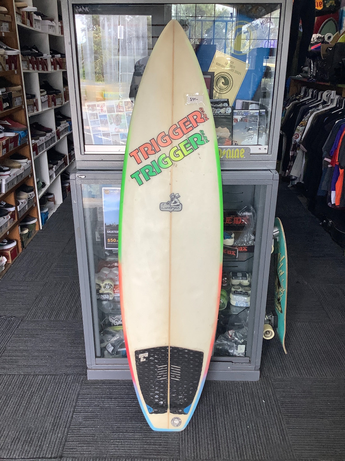 Used Trigger Brothers surfboard deck showing condition