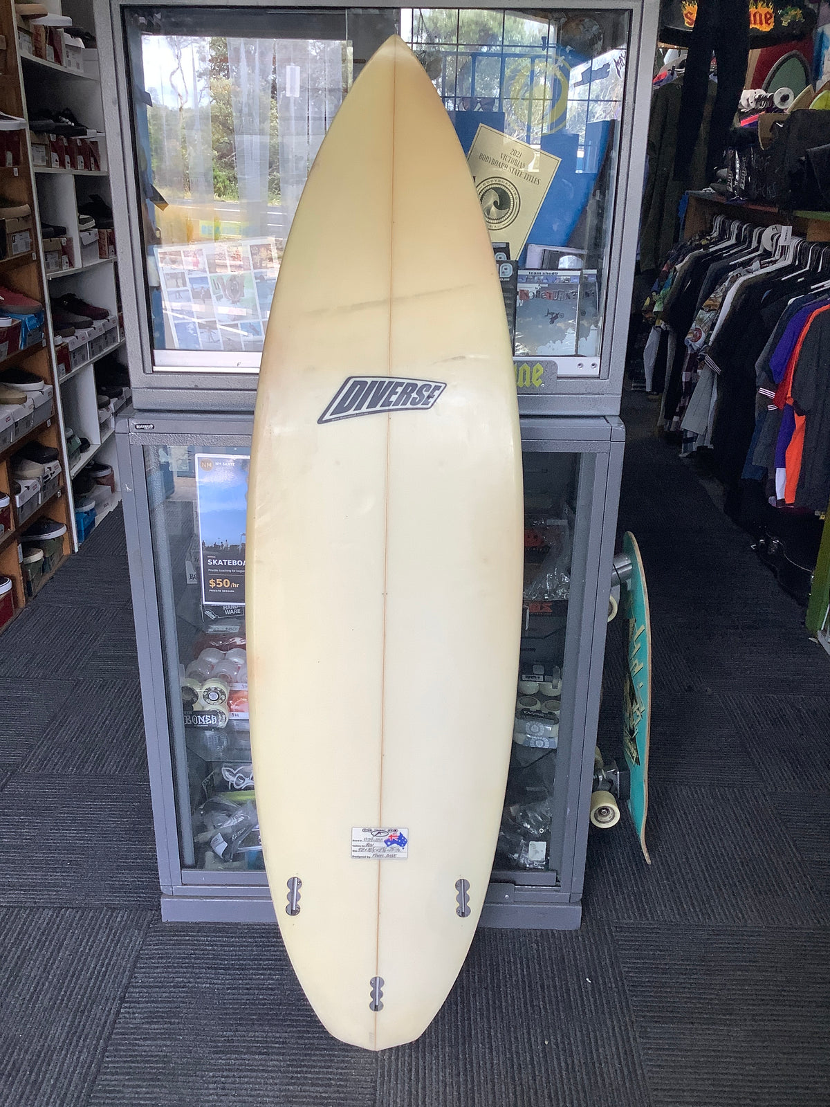 Used Diverse surfboard bottom with three fin boxes