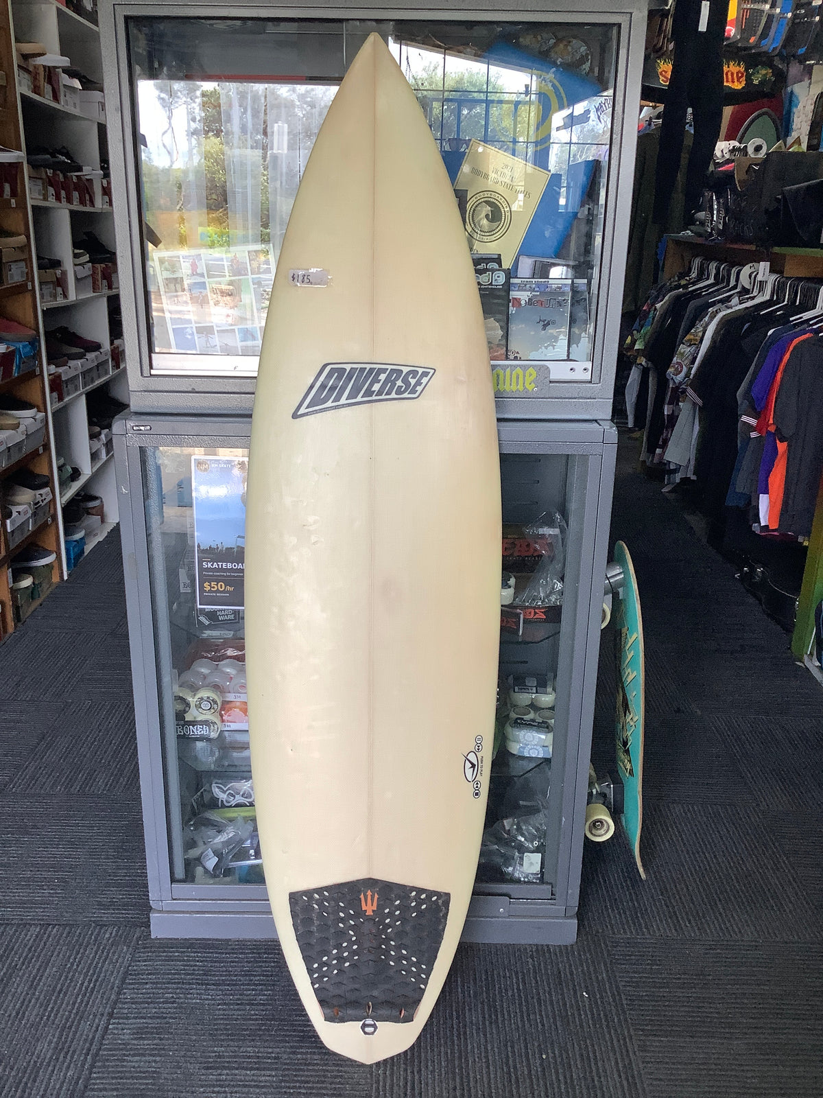 Used Diverse surfboard deck with cream finish and black tail pad