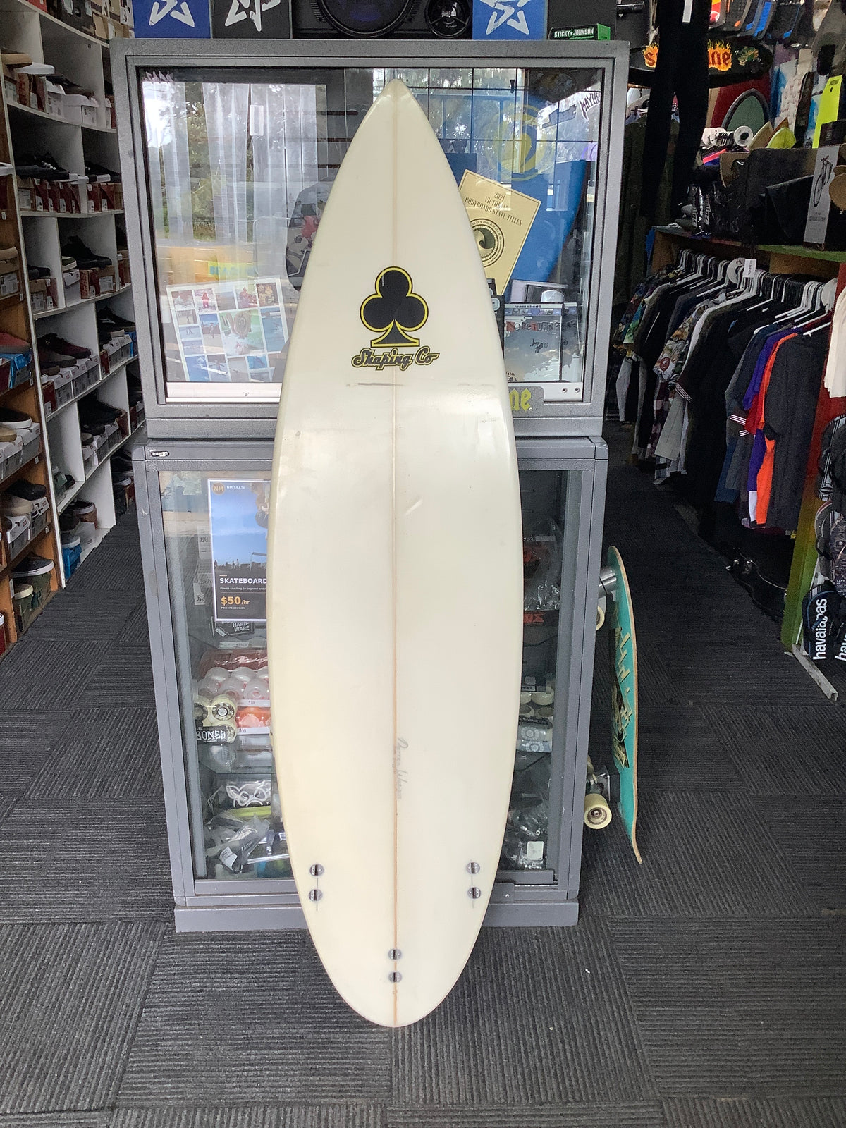 Used Darren Watson surfboard bottom with Shaping Co logo and FCS fin plugs