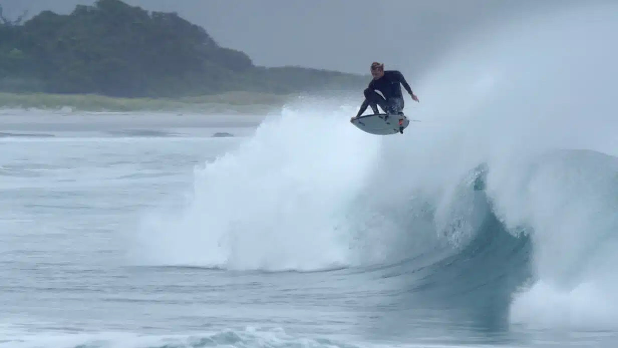 Action view of surfer in Zion Wesley 2/2mm GBS Long Arm Springsuit Wetsuit in black shed nine